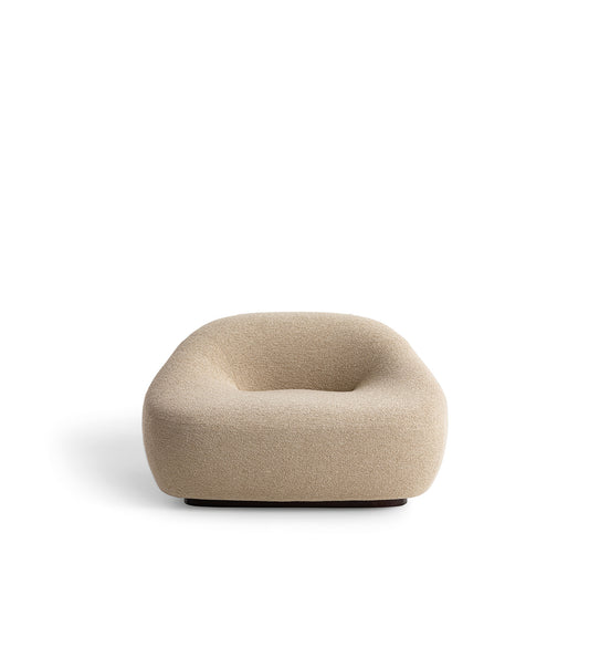 Contemporary luxury armchair with enveloping shape and tactile fabric, iconic design furniture by Fendi Casa