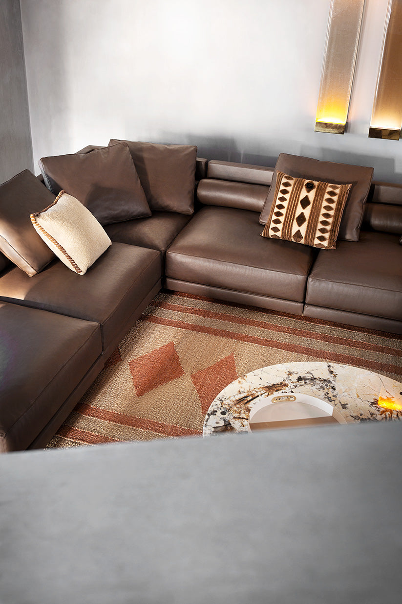White cushion accent on brown leather sofa, adding luxury design detail to contemporary living room furniture Fendi Casa