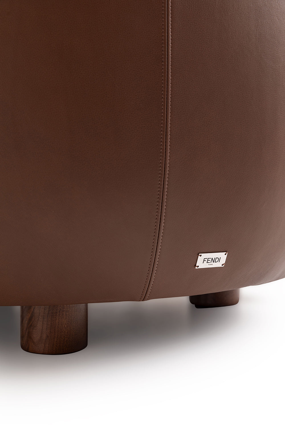 Luxury armchair back detail with leather upholstery, fine stitching and iconic metal logo, design furniture, Fendi Casa
